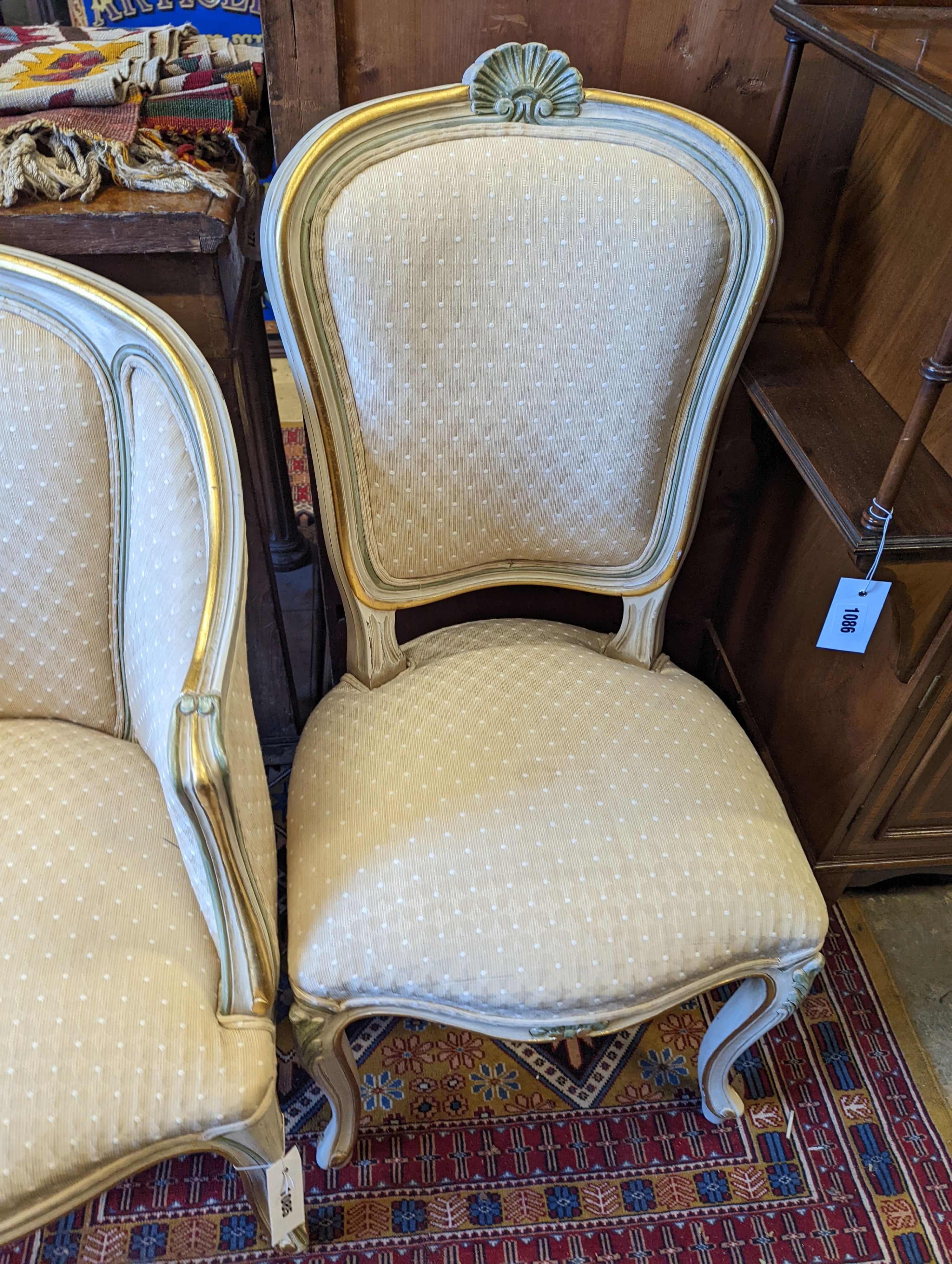 A Louis XVI style painted upholstered tub chair and a similar side chair